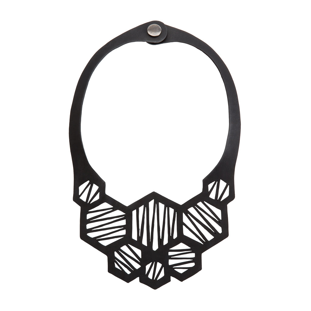 Paguro Upcycle black geometric recycled rubber necklace with honeycomb cutout and snap closure