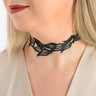 Paguro Upcycle black recycled rubber choker necklace with leaf pattern worn by a woman