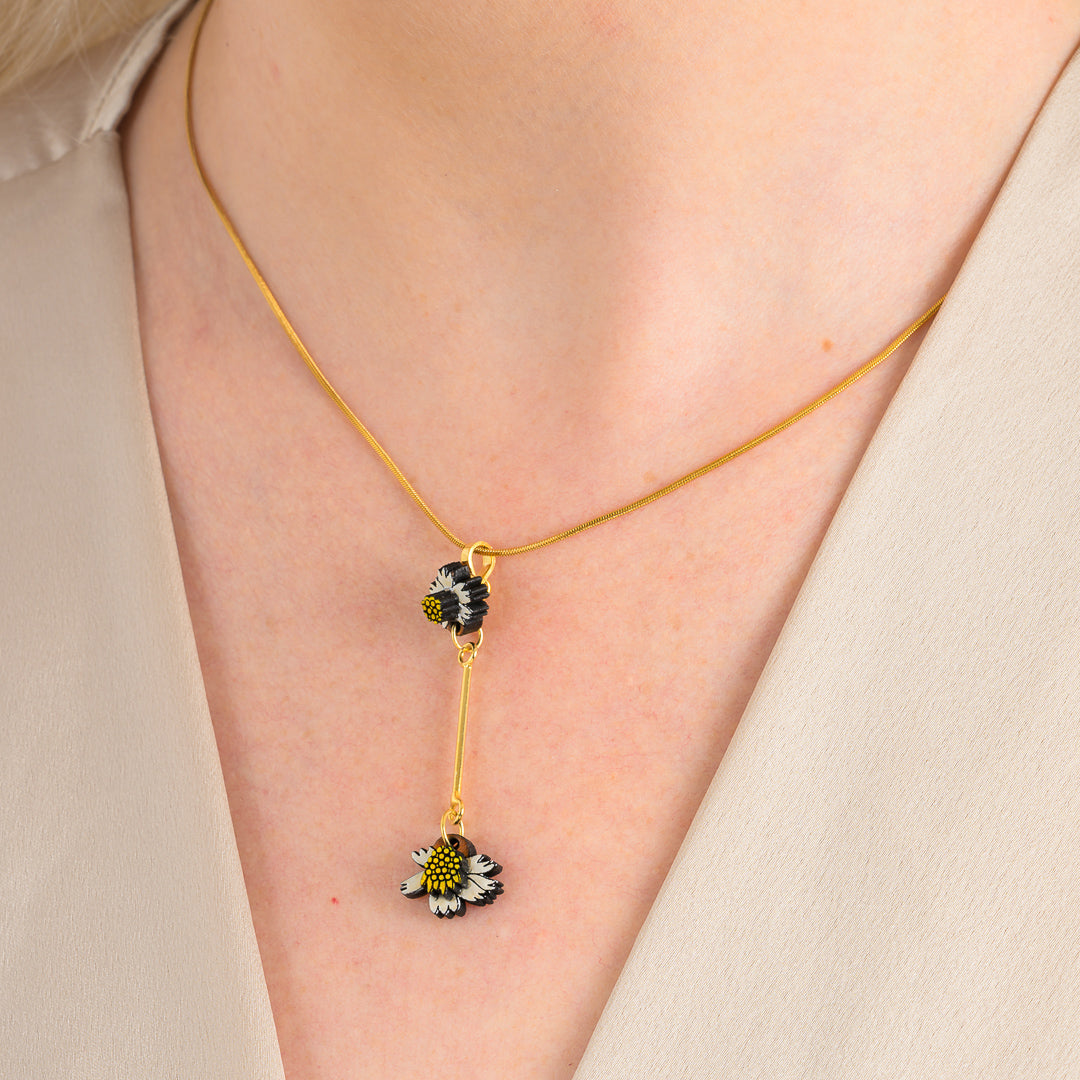 Paguro Upcycle reclaimed wood necklace with black and white floral design on gold chain