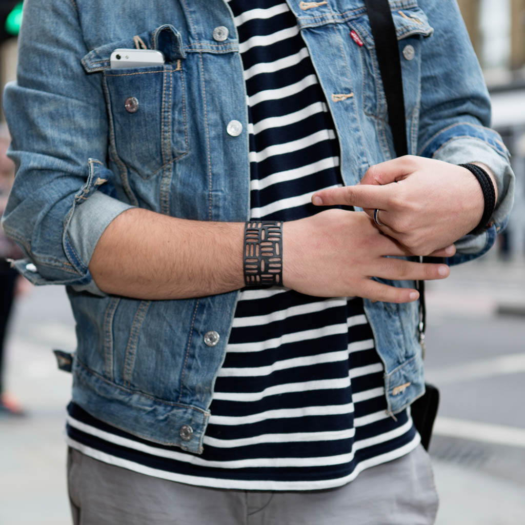 Paguro Upcycle recycled rubber bracelet worn on wrist with denim jacket and striped shirt