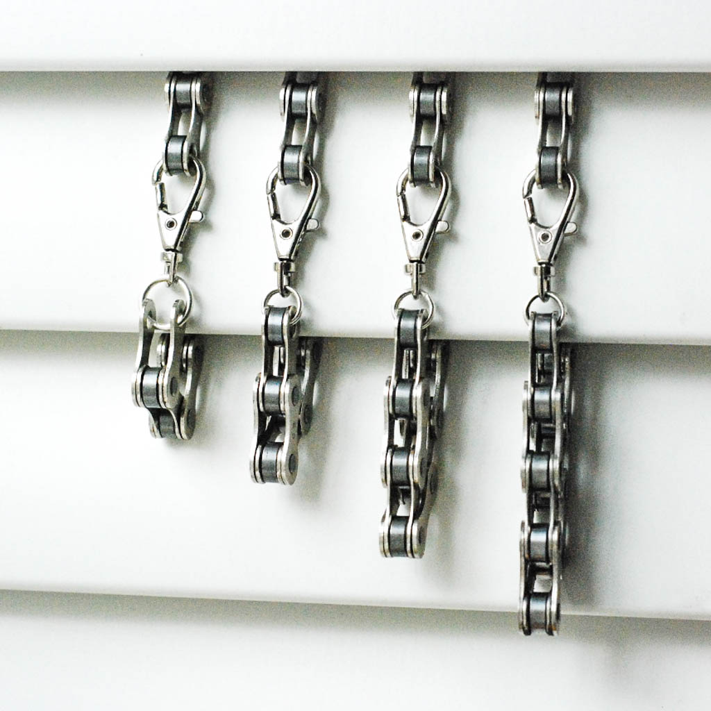Paguro Upcycle recycled bike chain bracelet in various sizes with metal clasps hanging on display