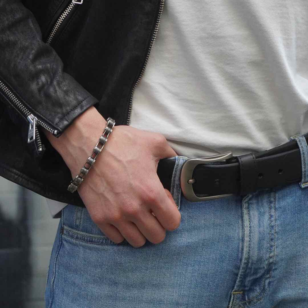 Stylish recycled bike chain bracelet worn on wrist with leather jacket and casual outfit