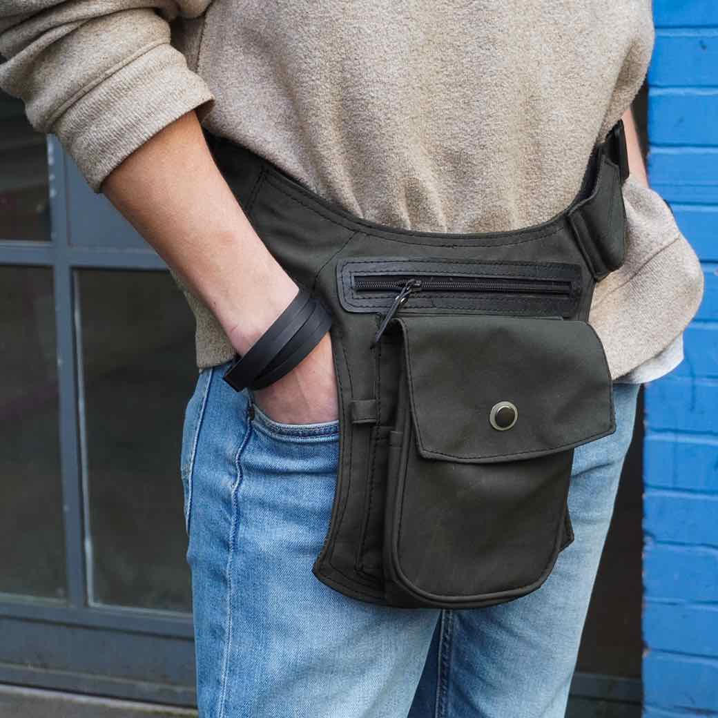 Paguro Upcycle recycled rubber bracelet worn on wrist with casual outfit and black utility belt bag