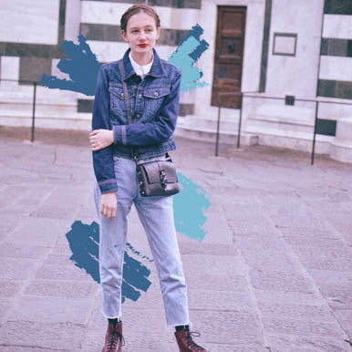 Young woman wearing a denim jacket and jeans with a recycle rubber vegan handbag for stylish, eco-friendly fashion