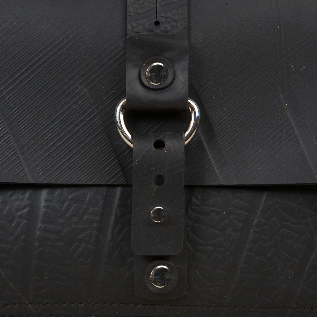 Close-up of a stylish recycle rubber vegan handbag with a secure fastening and textured surface