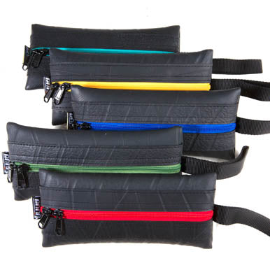 Paguro Upcycle recycled rubber pencil case with colorful zippers in blue, yellow, green, red, and teal