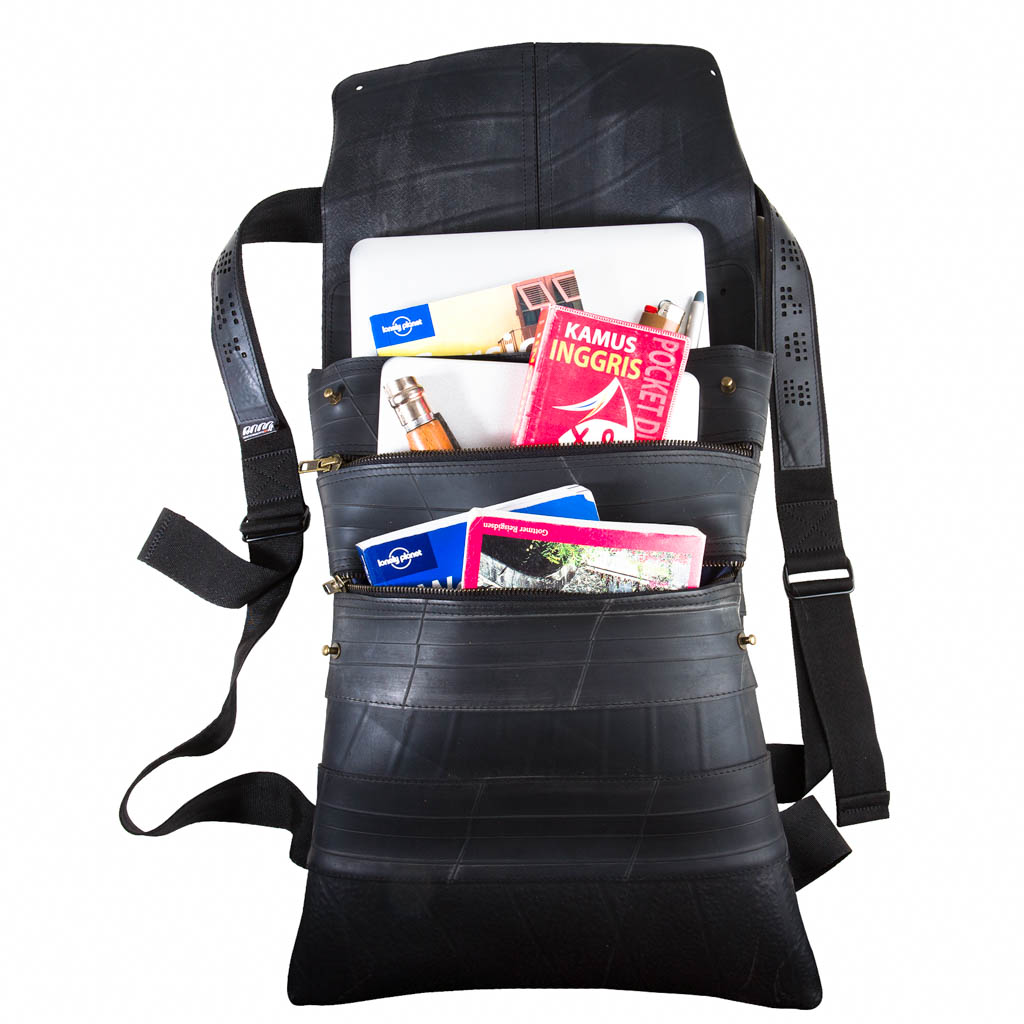 Paguro Upcycle vegan inner tube backpack with multiple compartments holding books and a laptop