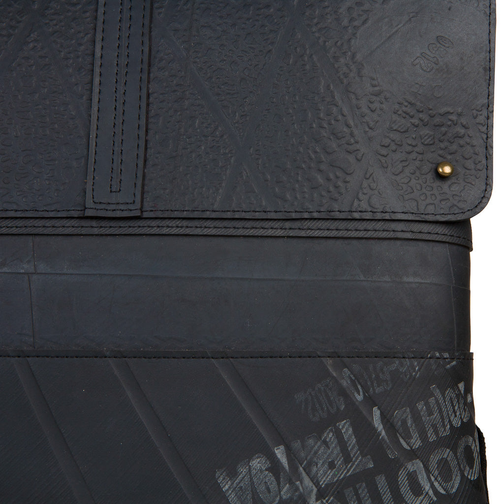 Close-up view of black vegan inner tube backpack showcasing textured material and zipper details