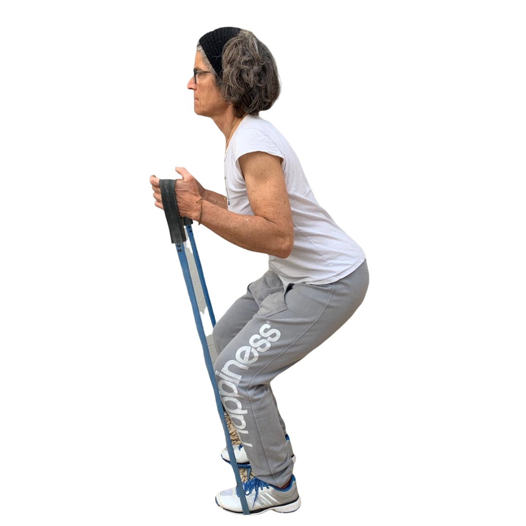 Woman exercising with a blue upcycled resistance band from Paguro Upcycle wearing gray pants and white shirt